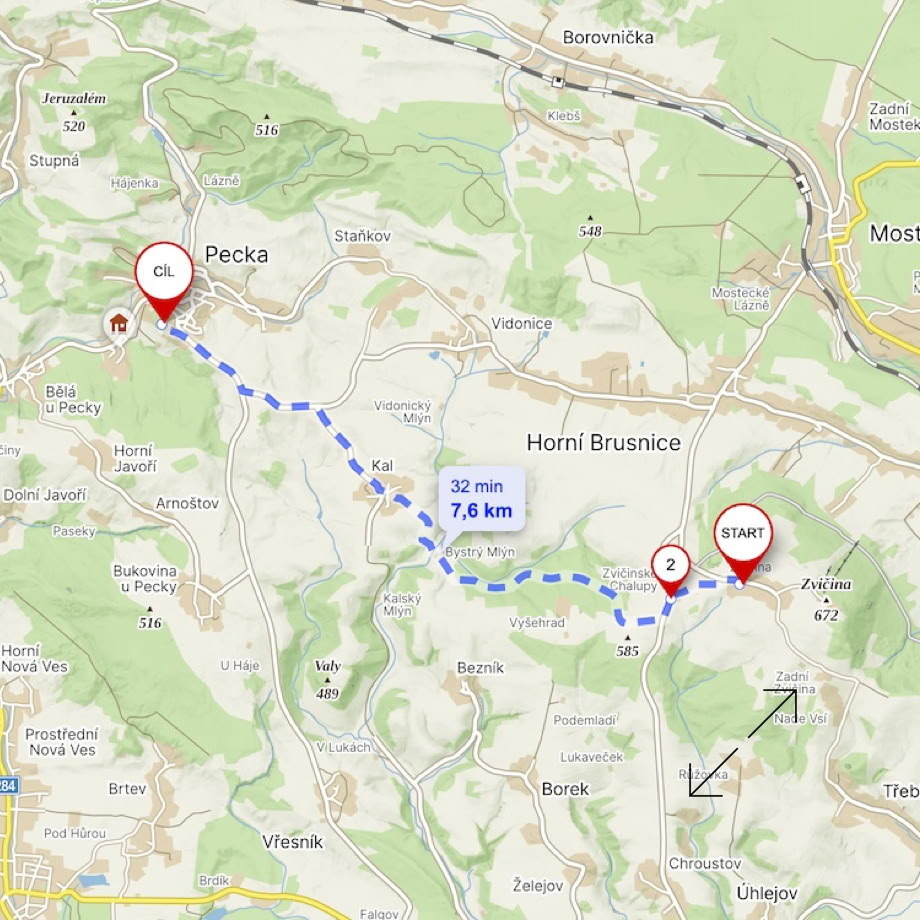 A picturesque A-frame wooden cabin set amidst lush mountains and blue skies.