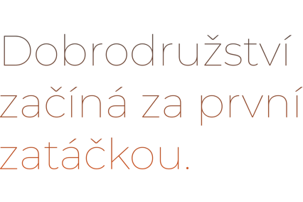 Text in Czech saying "Dobrodružství začíná za první zatáčkou."